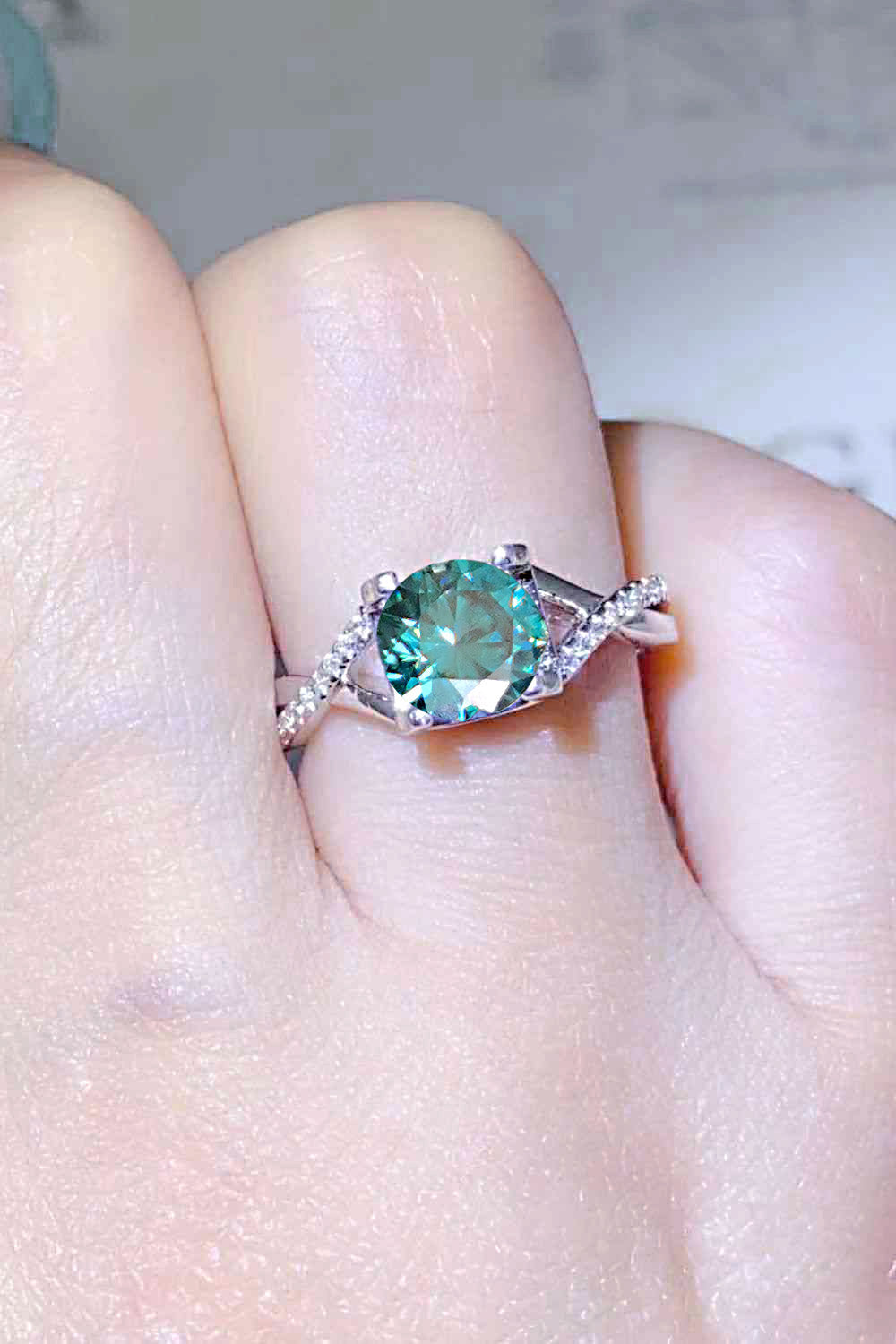 1 Carat Aqua Blue Brilliant Round Cut Sparkala™ Crisscross Platinum Over Pure Sterling Silver Ring