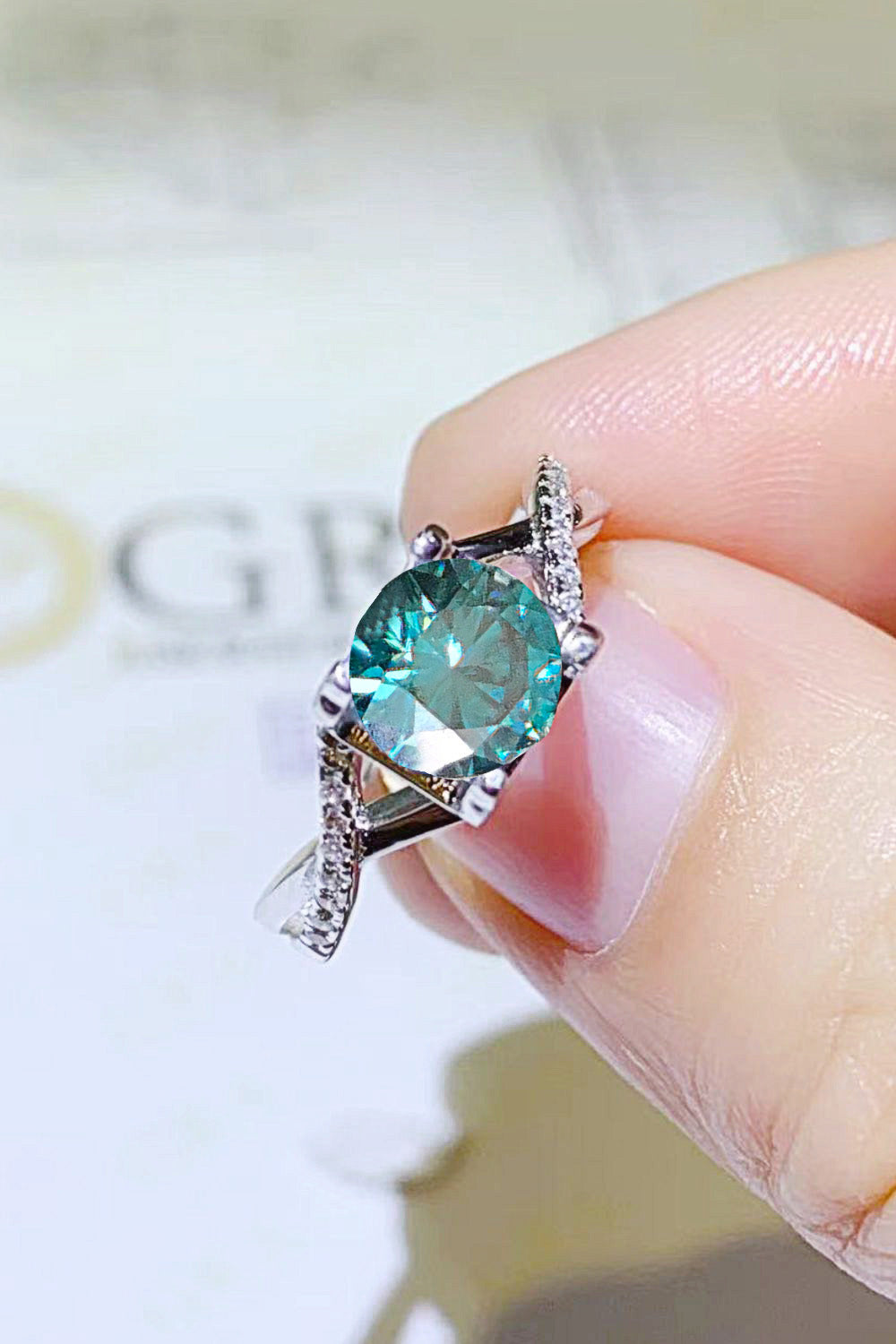 1 Carat Aqua Blue Brilliant Round Cut Sparkala™ Crisscross Platinum Over Pure Sterling Silver Ring