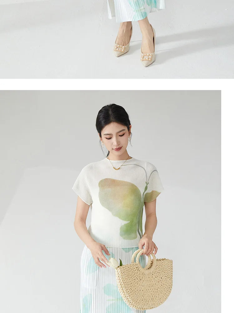 Summer women's outfit: a stylish two-piece set including a short-sleeved T-shirt and a pleated midi skirt with a slit.