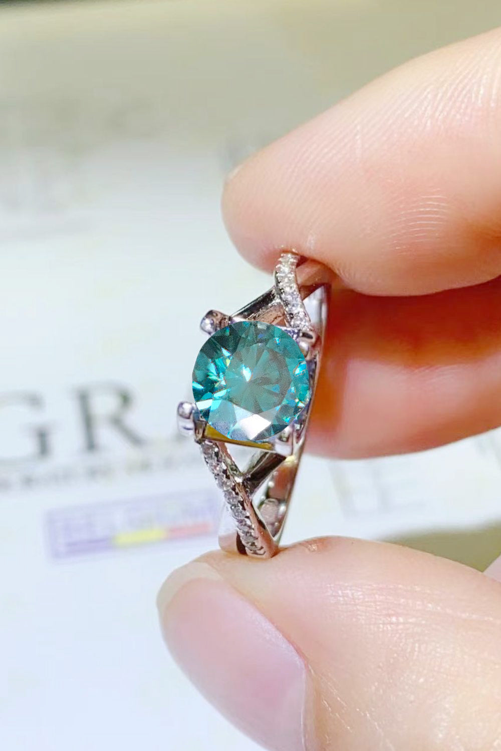 1 Carat Aqua Blue Brilliant Round Cut Sparkala™ Crisscross Platinum Over Pure Sterling Silver Ring